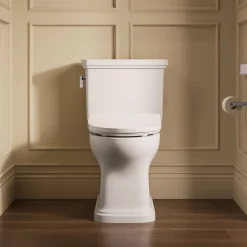Hidden cord two-piece elongated toilet with skirted trapway, 1.28 gpf