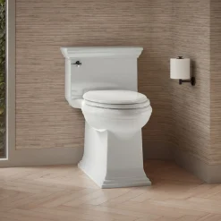 One-piece compact elongated toilet with skirted trapway, 1.28 gpf