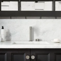 Rocker bathroom sink faucet handle