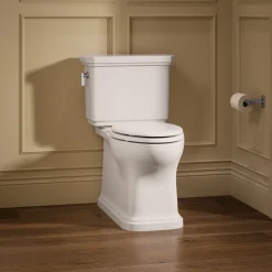 Two-piece elongated toilet with skirted trapway, 1.28 gpf