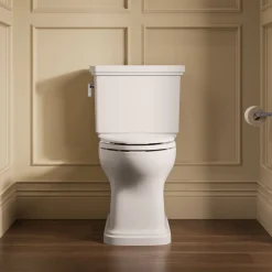 Two-piece elongated toilet with skirted trapway, 1.28 gpf
